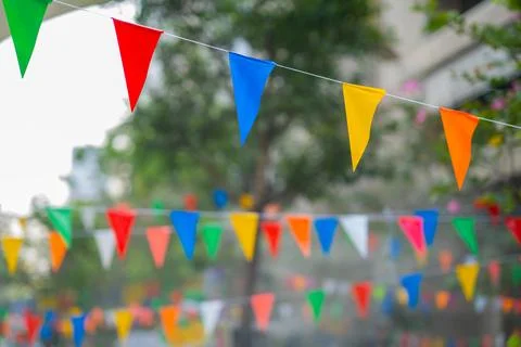 Decorative multi-colored triangle flags against the background Stock Photos