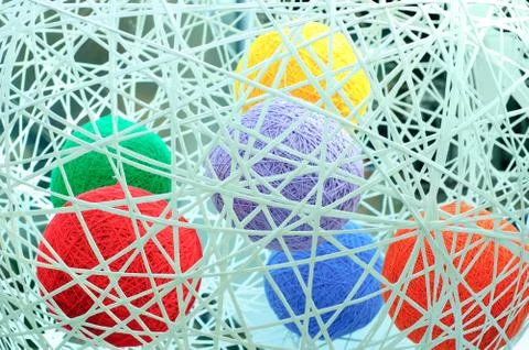 Decorative multicolored balls of thread of wool in the interior. Close-up. Stock Photos