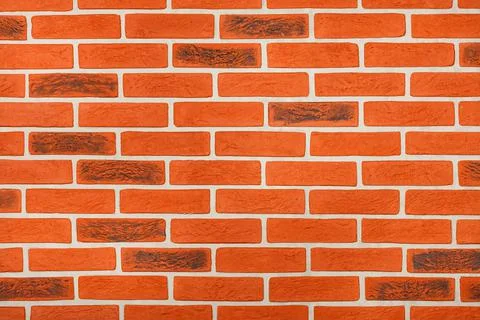 Decorative orange wall surface with horizontal imitation of brickwork with ne Stock Photos