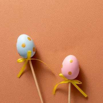 Decorative ornaments in the form of Easter eggs on a terracotta background. C Stock Photos
