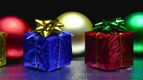 Decorative ornaments in a row. Large multi-colored balls. Gift boxes Stock Footage 164792439