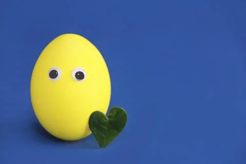 Decorative painted yellow Easter egg Stock Photos