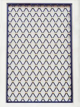 Decorative panel on the wall in the form of a black lattice with a diamond Stock Photos