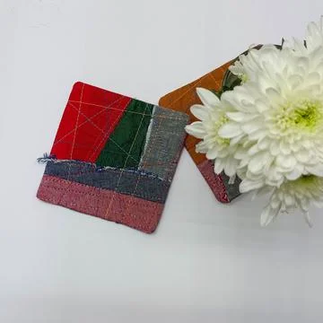 Decorative patchwork coasters with geometric fabric design.  Fotos de archivo