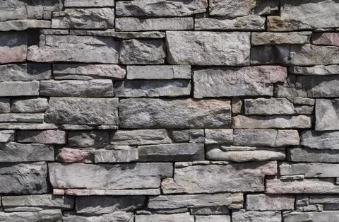 Decorative pattern of stone wall surface. Stone background texture. Stock Photos