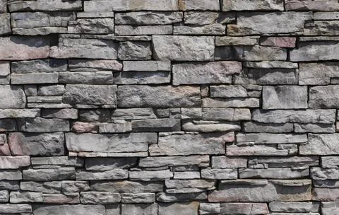 Decorative pattern of stone wall surface. Stone background texture. Stock Photos