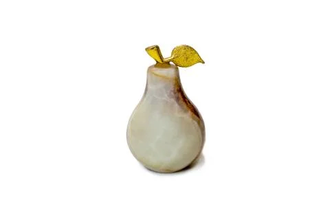 Decorative pear made of natural stone with a gilded twig on a white background Stock Photos