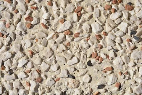 Decorative pebble dash wall texture with white and terracotta stones Stock Photos