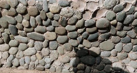 Decorative Pebble Stone Wall Made of Small Colorful Rocks on Cement Background Stock Photos