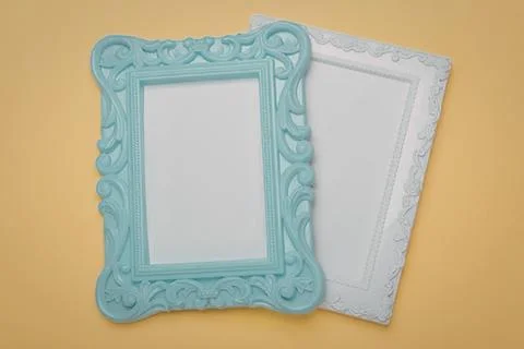 Decorative photo frames on yellow background for home decor Stock Photos