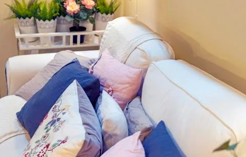 Decorative pillows on a white sofa in the interior of a modern living room. Stock Photos