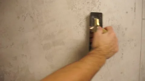 Decorative plaster coating. Man puts a plaster on the wall. Using gold spatula. Stock Footage 144865958