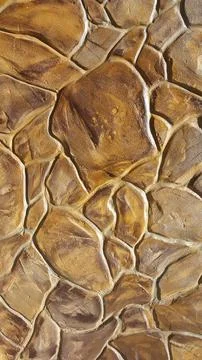 Decorative plaster under a stone. Artificial stone. Vintage background Stock Photos
