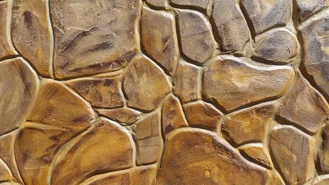 Decorative plaster under a stone. Artificial stone. Vintage background Stock Photos