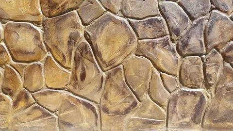 Decorative plaster under a stone. Artificial stone. Vintage background Stock Photos