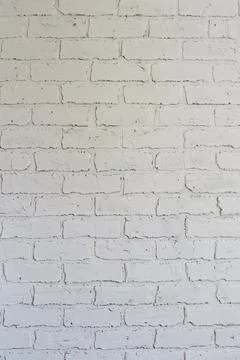 Decorative plaster on the wall in the form of white brickwork can be used as  Stock Photos