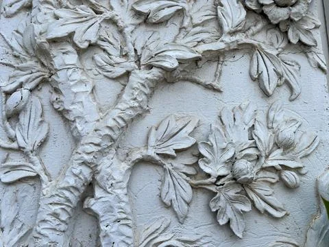 Decorative plaster on the wall of an old building, closeup of photo Stock Photos