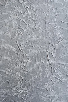 Decorative plaster on wall, textured background close up Stock Photos