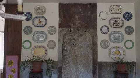 Decorative Plates on Wall Beside Granite Stone Slab Stock Footage 347125527