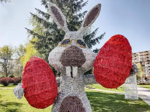 A decorative rabbit holding two Easter eggs in Baia Mare city Stock-Fotos