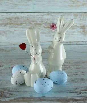 Decorative rabbits and Easter eggs on a wooden background Stock Photos