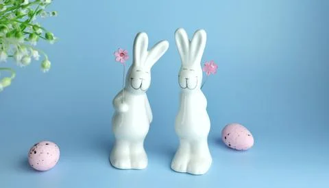 Decorative rabbits and Easter eggs on a wooden background Stock Photos