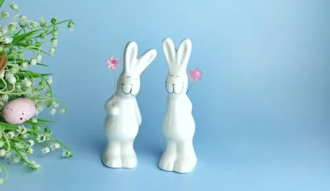 Decorative rabbits and Easter eggs on a wooden background Stock Photos