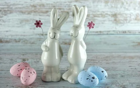 Decorative rabbits and Easter eggs on a wooden background Stock Photos