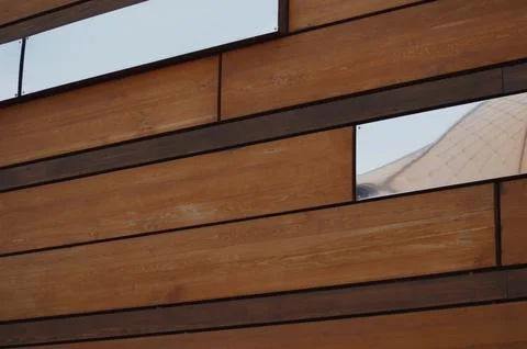 Decorative rectangular brown slats of wood and mirrors arranged in an abstr.. Stock Photos