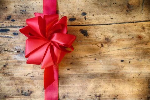 Decorative red bow on rustic wood background Stock Photos