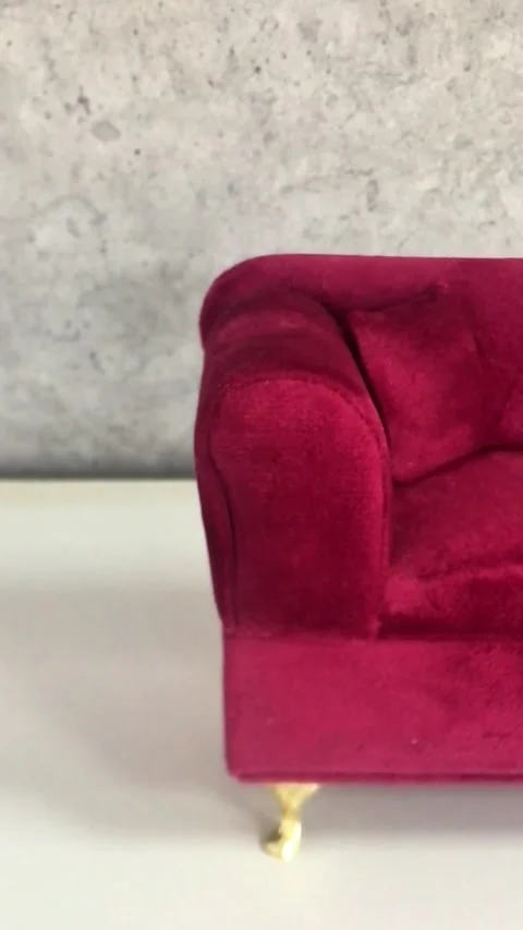 A decorative red sofa in miniature, a handcrafted red luxury couch Stock Footage 270184284