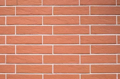 Decorative relief cladding slabs imitating bricks on wall 库存照片