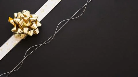 Decorative ribbon bow silver string black background. High quality photo Stock Photos