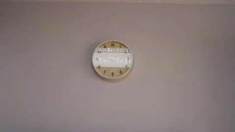 Decorative Round Wall Clock On Plain Wall Stock Footage 333576666