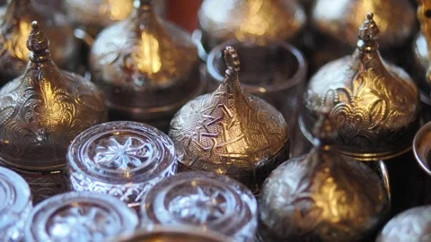 Decorative silver containers and glass in a market Stock Footage 342089111