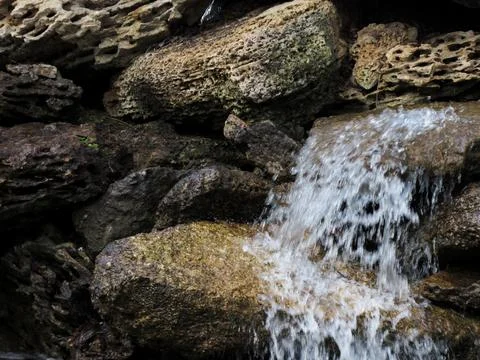 Decorative small waterfall in the park Stock Photos