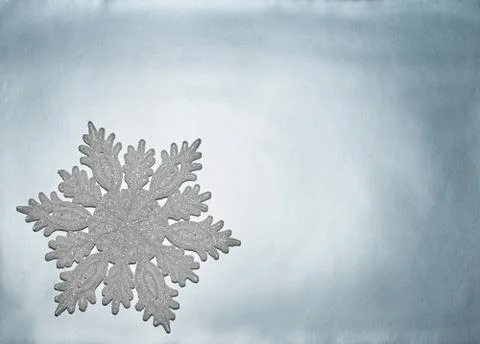 Decorative snowflake lies on a silver background Stock Photos