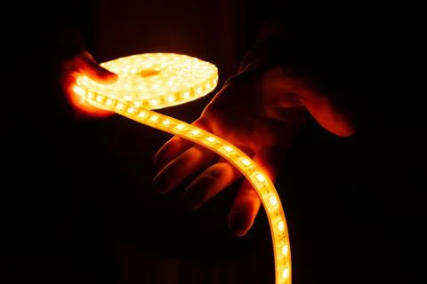 Decorative soft led light, diode lighting logo in hand Stock Photos