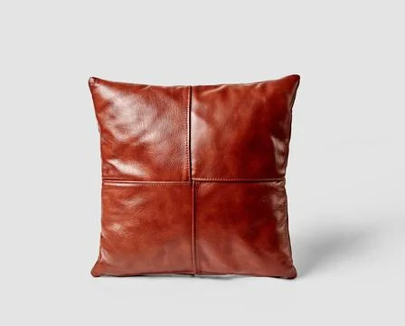 Decorative square couch cushion made of smooth copper-colored leather Deco... Stock Photos
