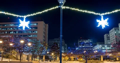 Decorative stars hanging on light posts in park during Christmas season Stock Footage 71847746