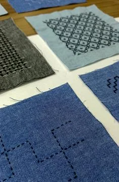 Decorative stitched fabric surface in macro view.  Fotos Stock