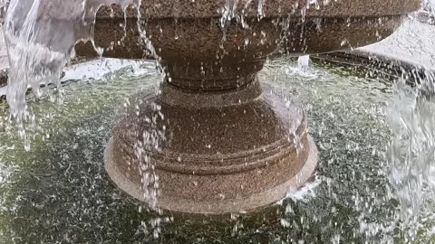 Decorative stone fountain with continuous flowing water Stock Footage 320831382