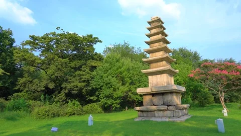 Decorative stone multi tiered pagoda in Seoul Park, panoramic video. Bright g Stock Footage 121878317