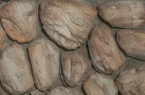Decorative stone on the wall with a cement base. Stones for decorating the Foto stock