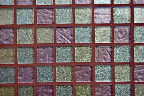 Decorative surface made of multi-colored squares of tiles Stock Photos