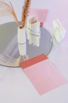 Decorative table setting with mirror, vase, and stationery elements Stock Photos