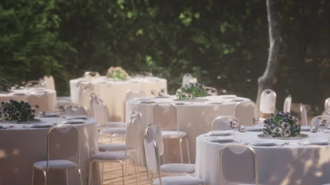 Decorative tables set for an outdoor wedding event in a green area Stock Footage 344100076