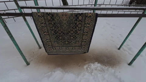 Decorative textile drying, Traditional Persian rug displayed outdoors amidst Stock Footage 327417335