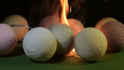 The decorative threads of the balls begin to burn, sparks and smoke are visible  Stock Footage 323145440