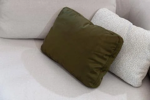 Decorative throw pillows on light beige sofa with copy space Stock Photos